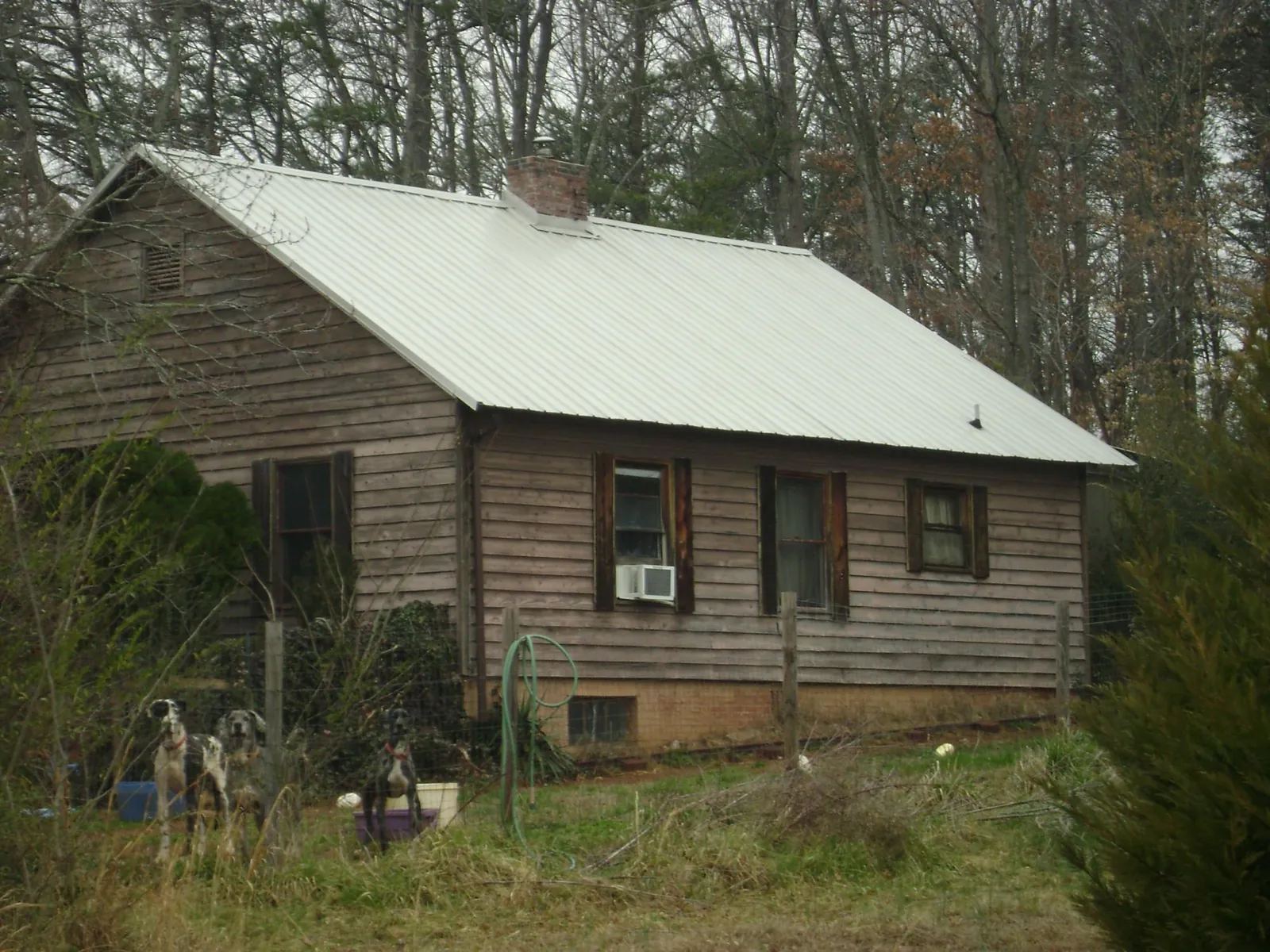 White metal roof on an old wood sided farmhouse, from a Metal Roof Installation job in Kesley